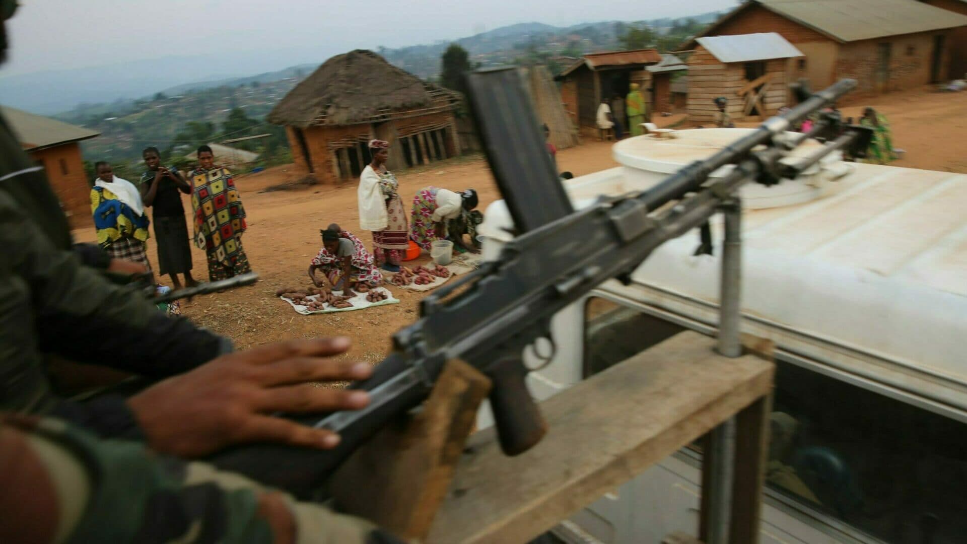 Soldiers with a weapon passing a group of people along the way. Soldiers with a weapon passing a group of people along the way.