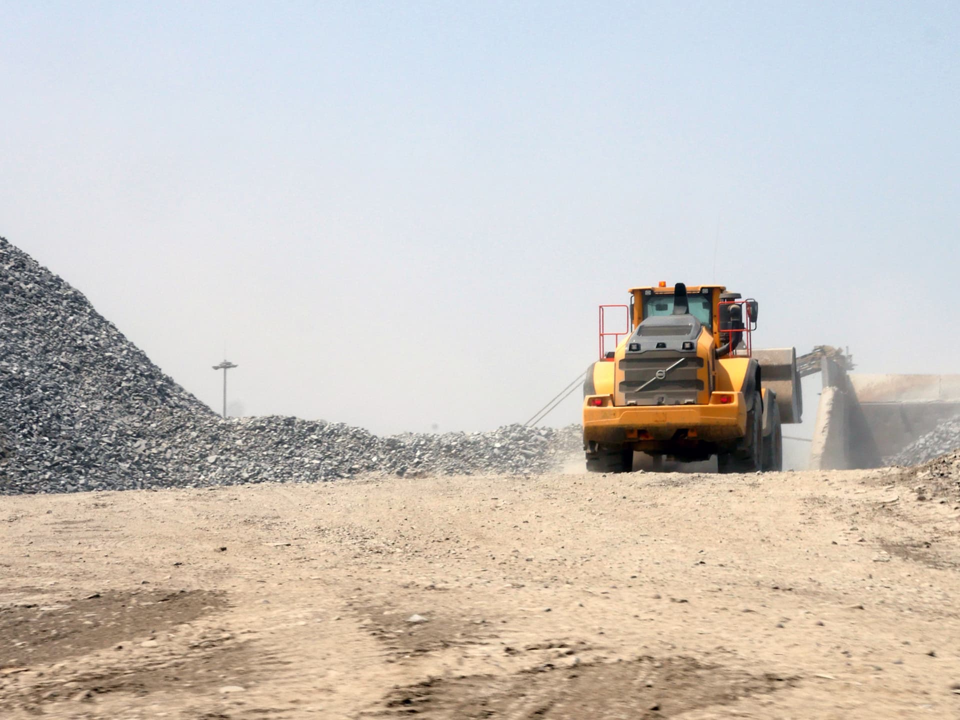 Gult fordon arbetar i grustag