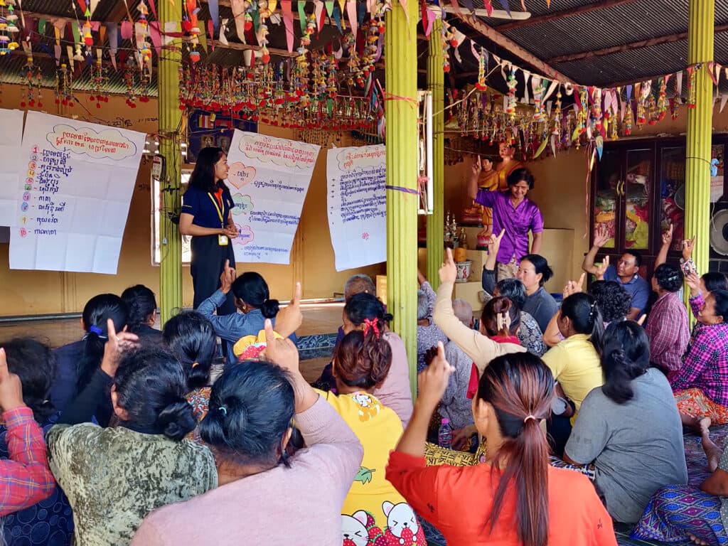 A man and a woman standing inb front of a group of people
