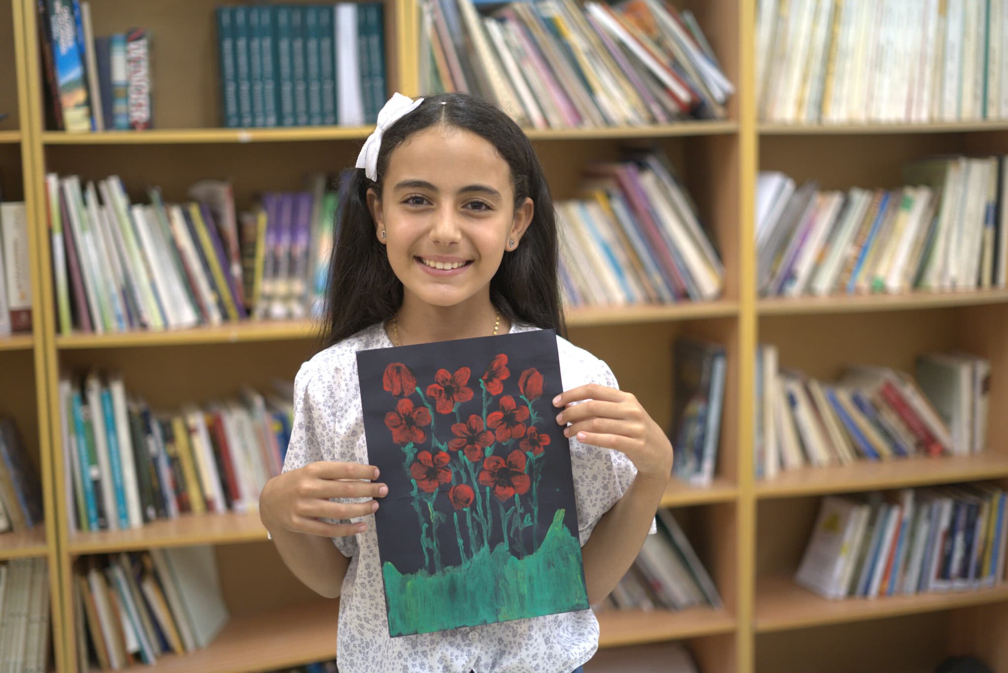 Nagham Hashem Asad, 12 years, lives outside Jenin in the West Bank and regularly takes part in Tamer Institute´s activities. "The library and the activities are really important for us kids here. We grow as individuals and get the chance to connect with new people. I believe the library makes me a better person—I’m growing," says Nagham. Photo: Ahmad Daghlas
