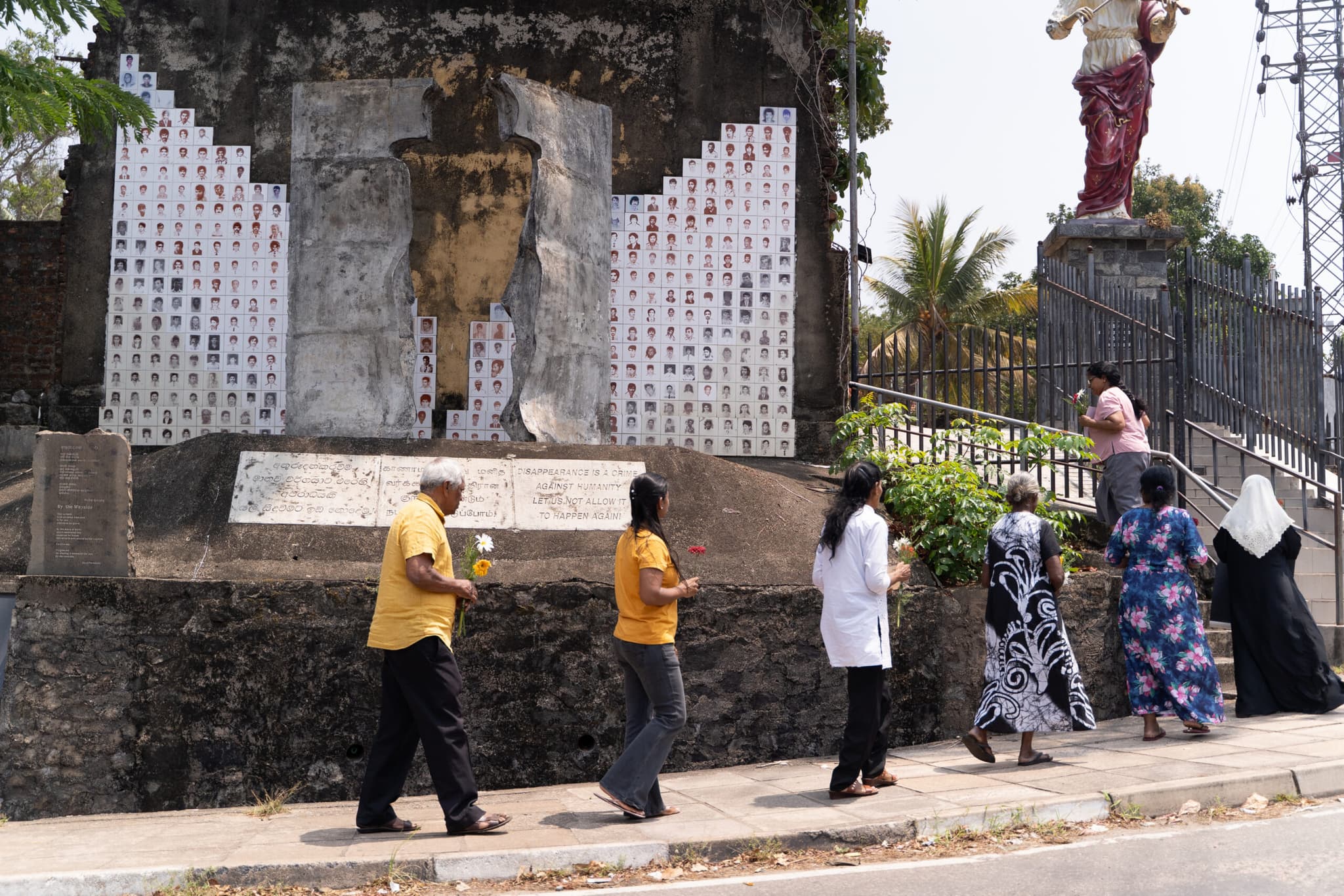 Brito Fernando and families of the disappeared walk around the monument to remember those who have been lost and disappeared.