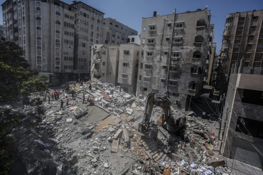 Rubble in the middle of the city and high appartement buildings in the background. Rubble in the middle of the city and high appartement buildings in the background.