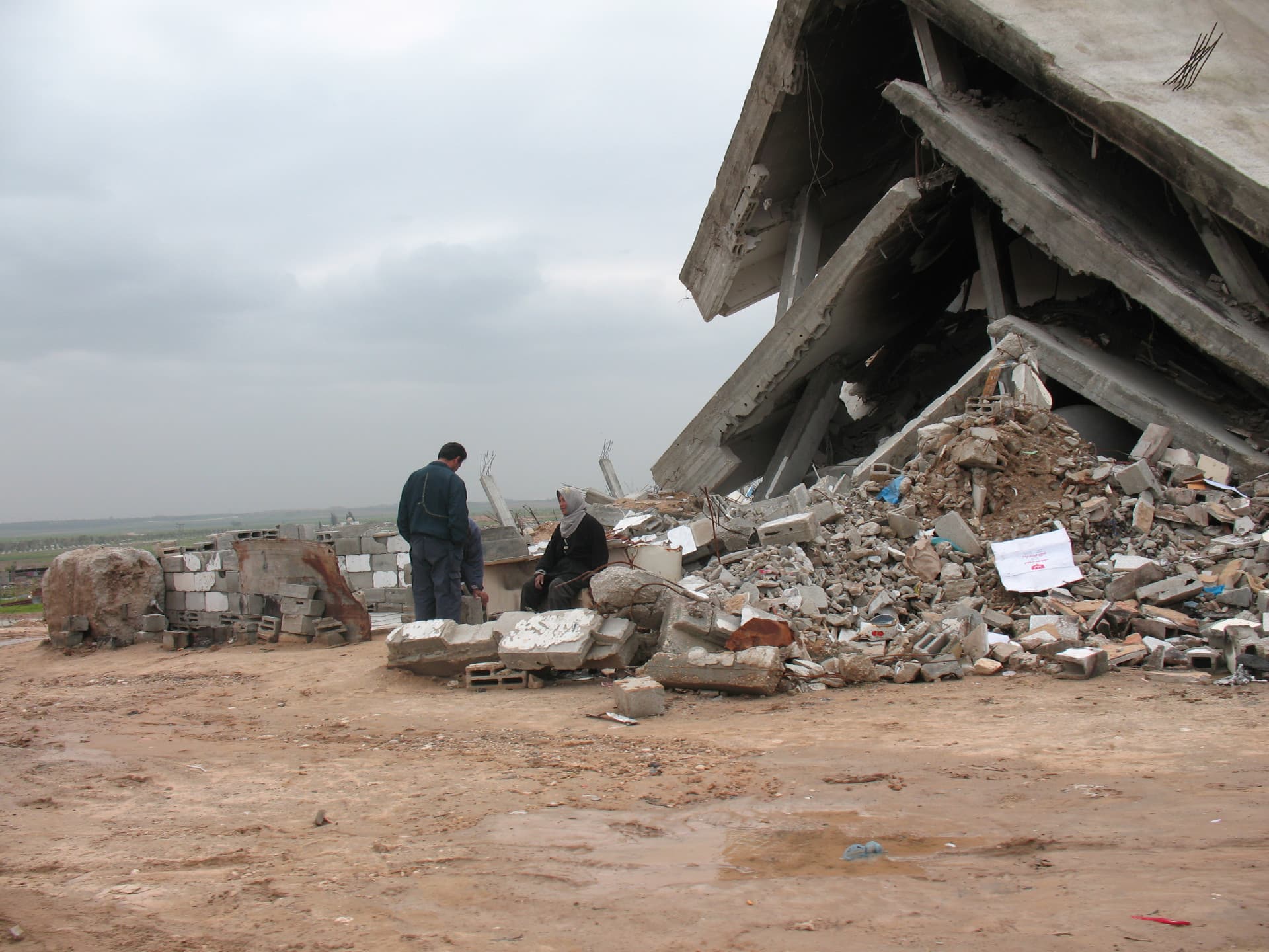 A man and a woman in front of destroyed building. A man and a woman in front of destroyed building.