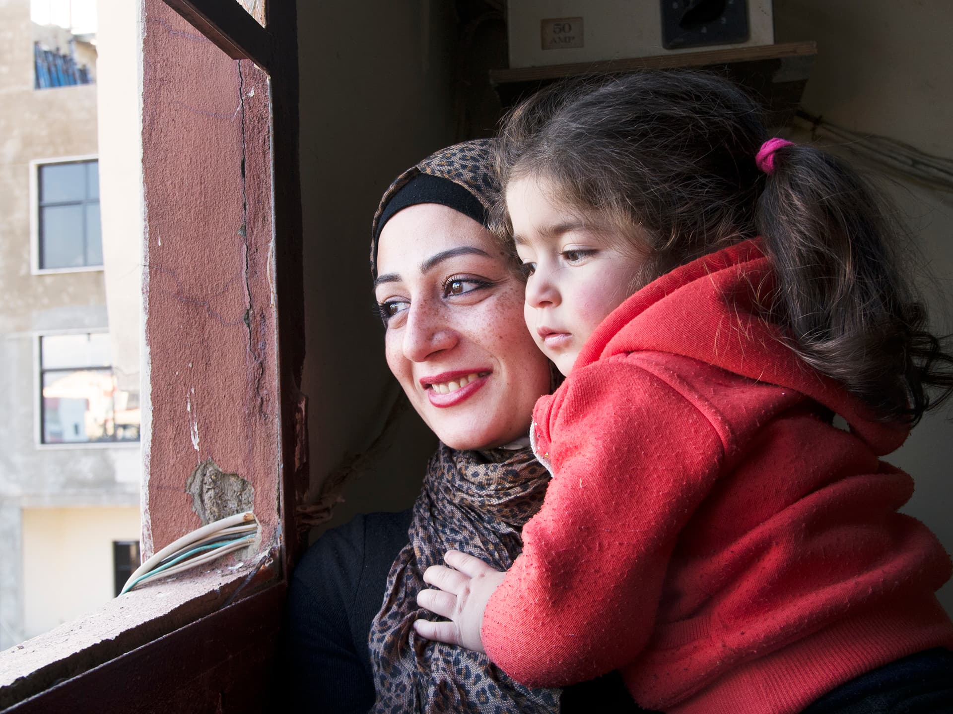 Photo: Lina Malers A Palestine woman and her child looking out through a window
