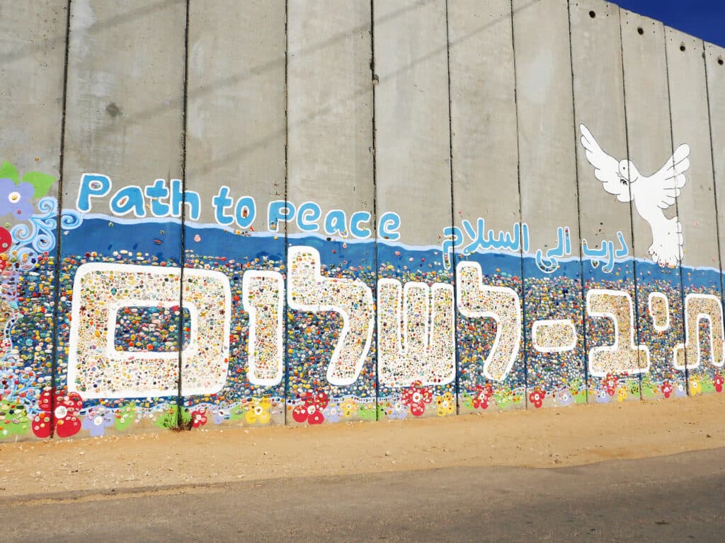 Photo: Diakonia Image of a concrete wall with a mural that says "Path to peace".