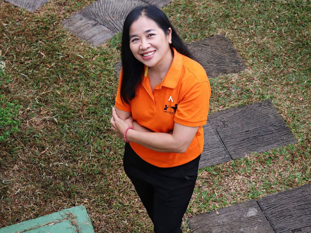 A woman in an orange t-short is seen from above.