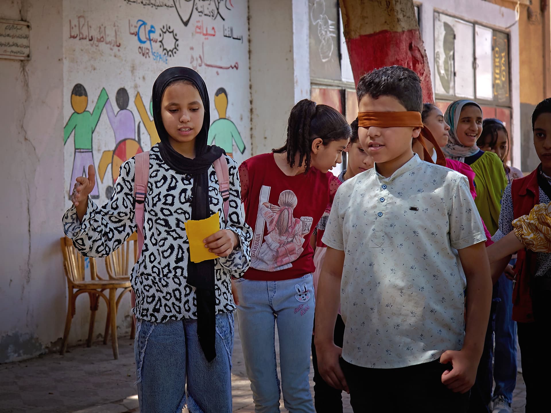 Foto: Sima Diab En grupp barn står på en skolgård.
