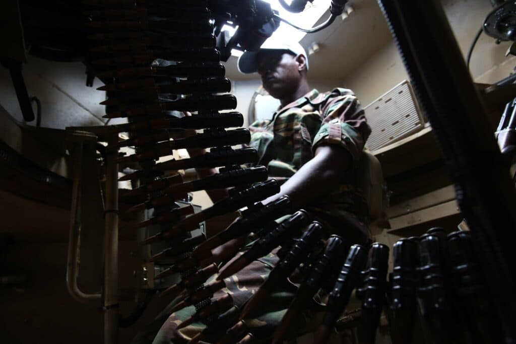 A soldier inside a military vehicle.