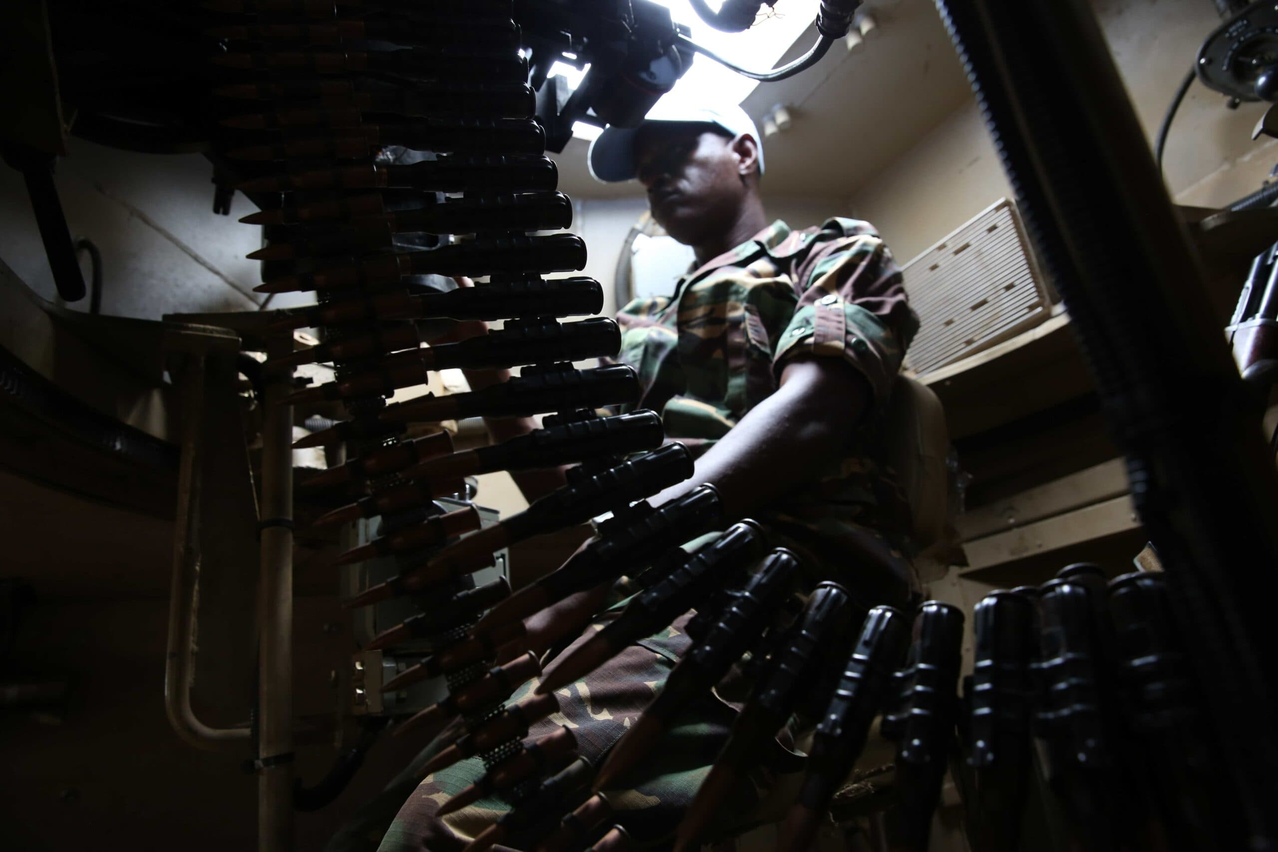A soldier inside a military vehicle. A soldier inside a military vehicle.