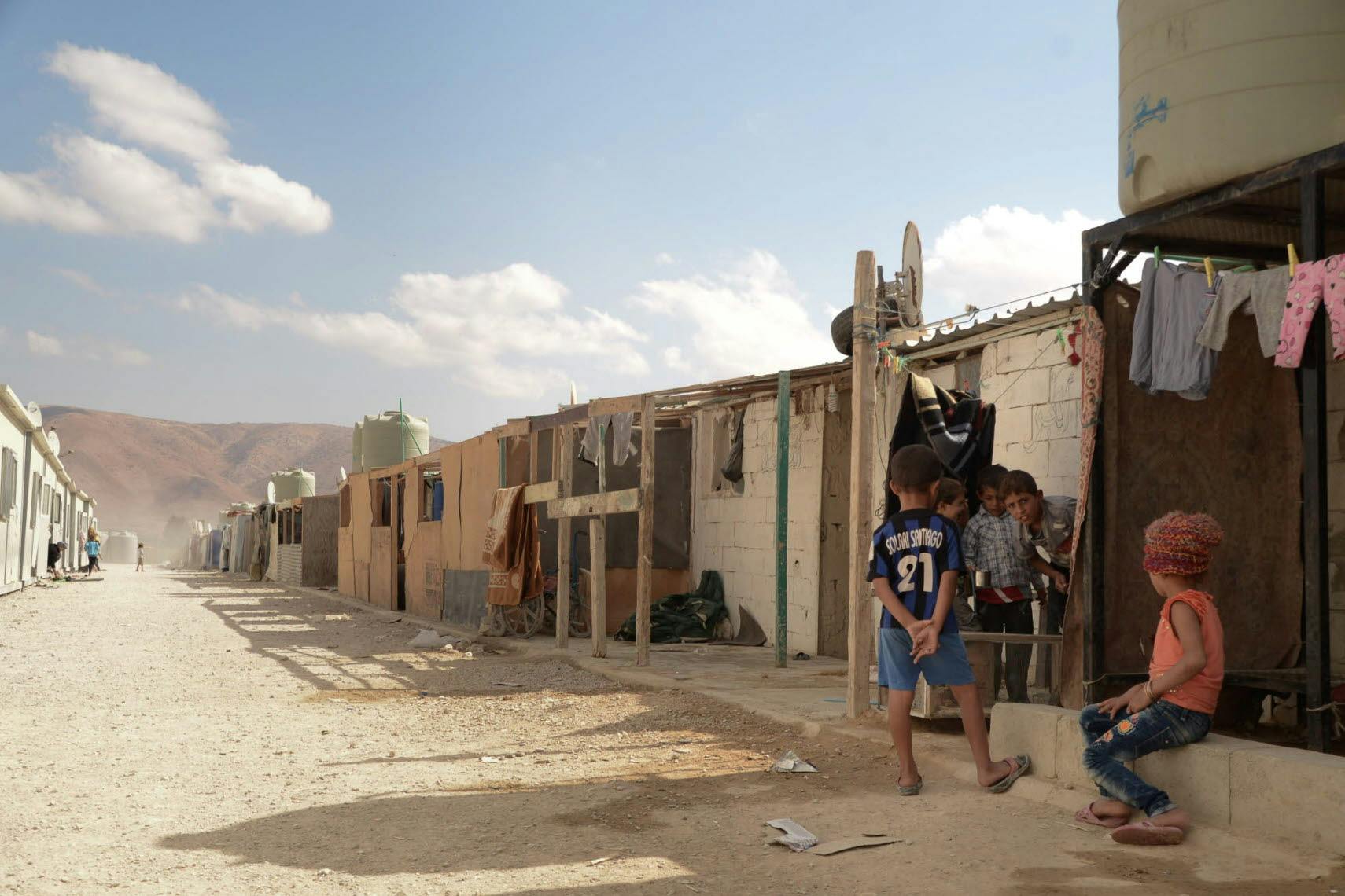 A street with barracks of a camp for displaced people.