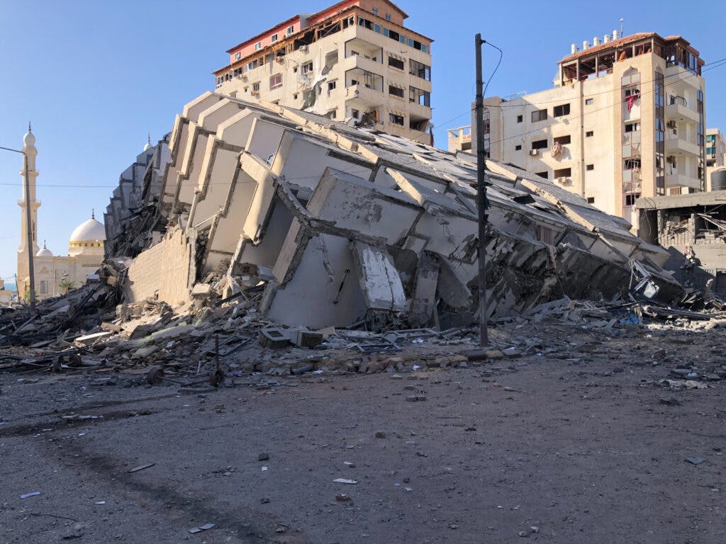 A collapsed building in the middle of the city.