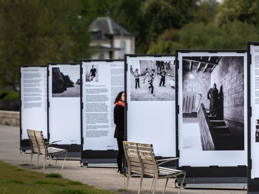 A person standing between panels of an exhibition.