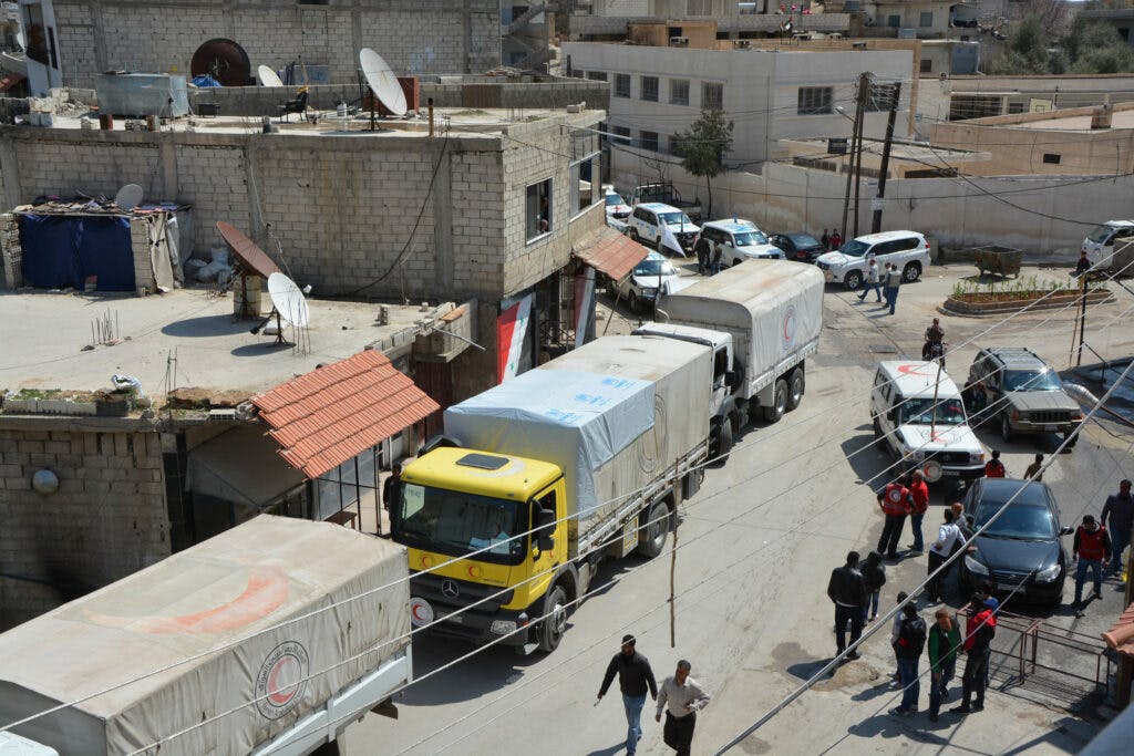 A convoy of trucks in a Syrian town.