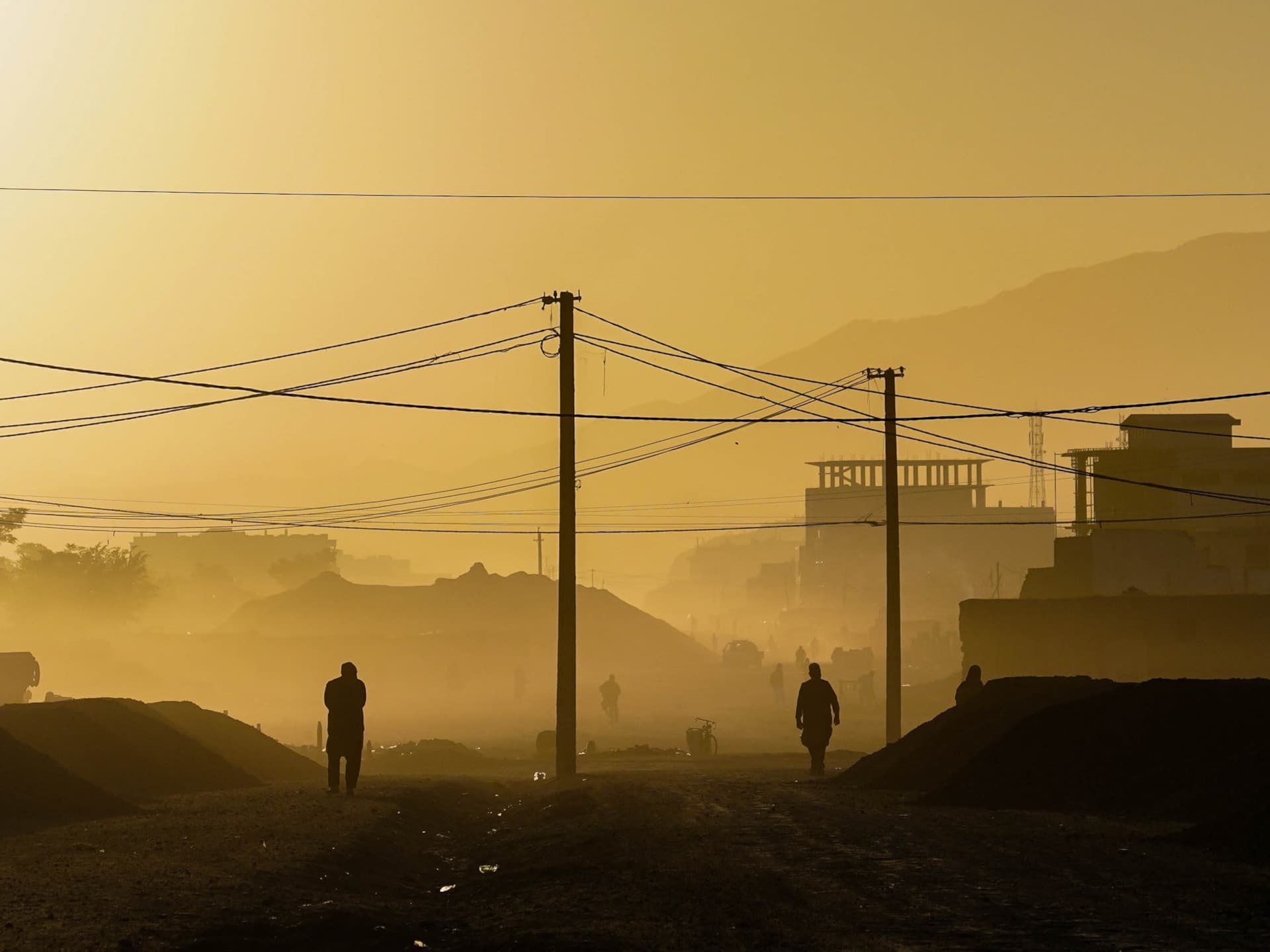 The silhouettes of people walking on the street in the Afghan capital Kabul as the sun rises. The silhouettes of people on the street in the Afghan capital Kabul as the sun rises.