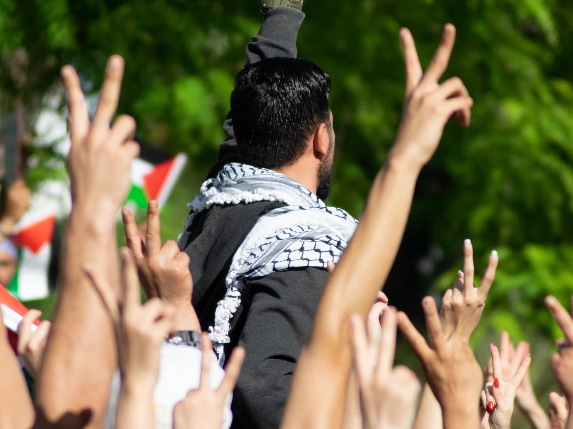 People in Tunis raising their hands at a solidarity demonstration for Palestinians. People in Tunis raising their hands at a solidarity demonstration for Palestinians.