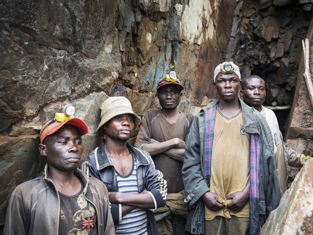 A group of Congolese mine workers are standing in a mine.