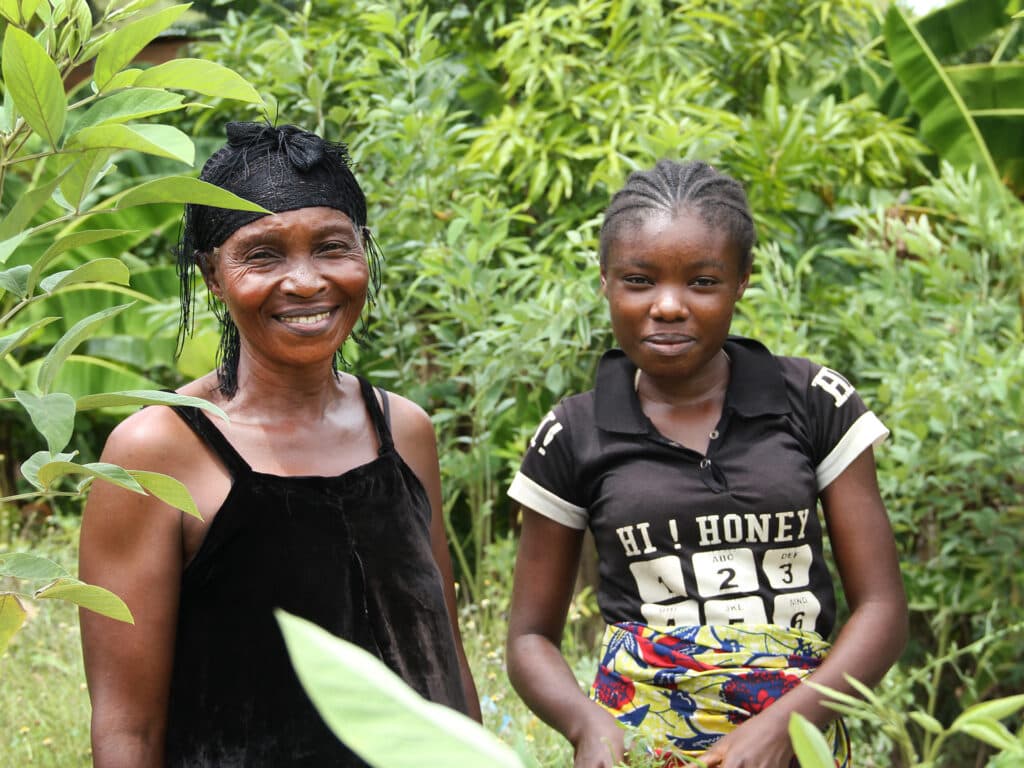 Victorine standing next to her daughter