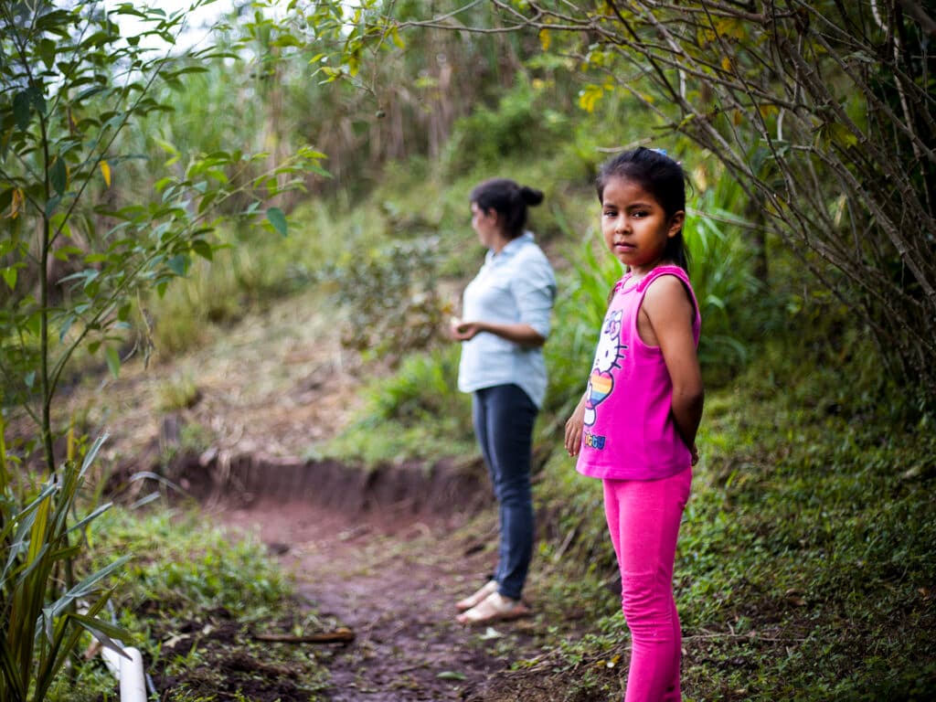 Children standing in a tropical forest