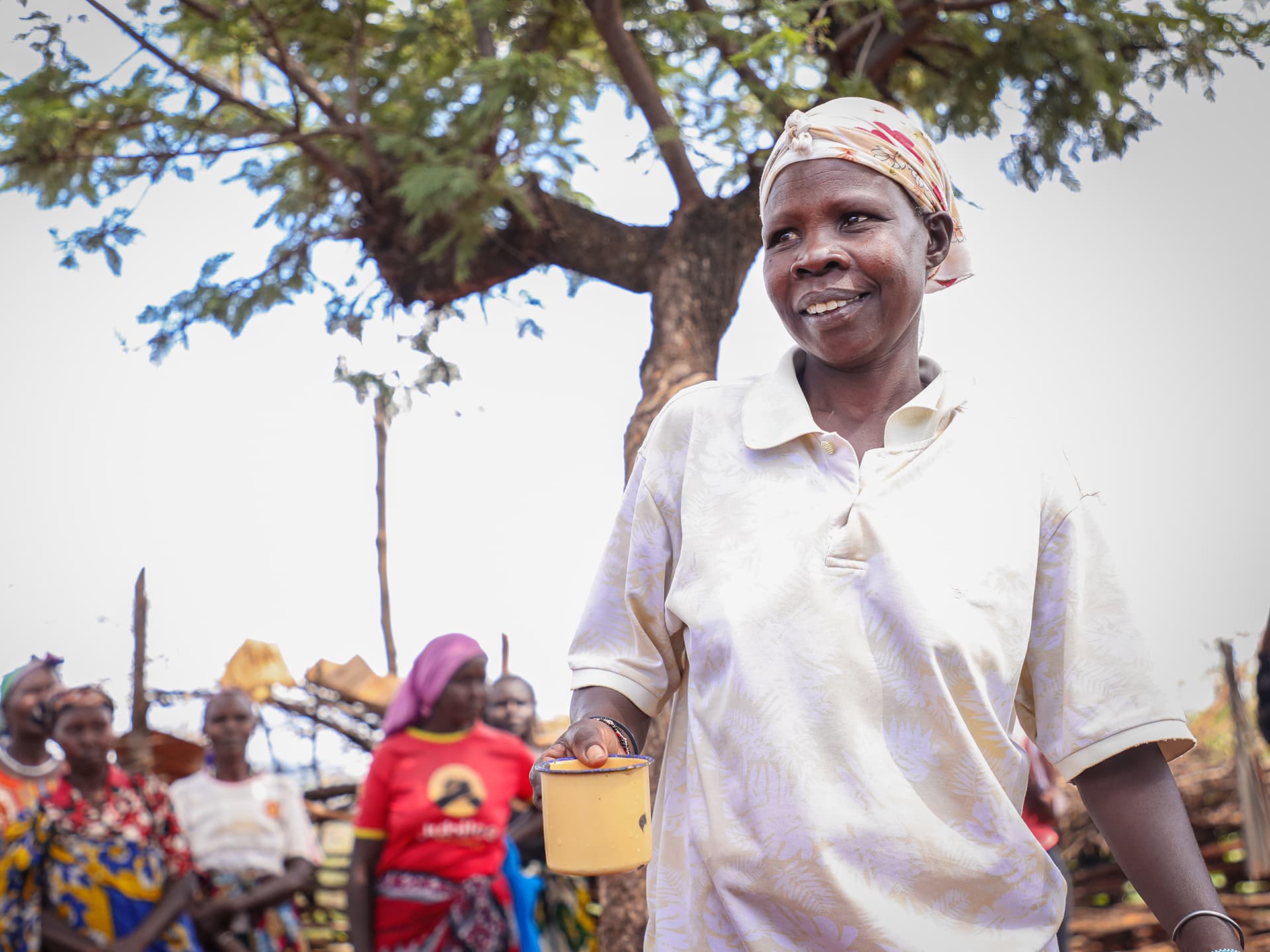 A portrait of a Kenyan farmer. A tree in the background.