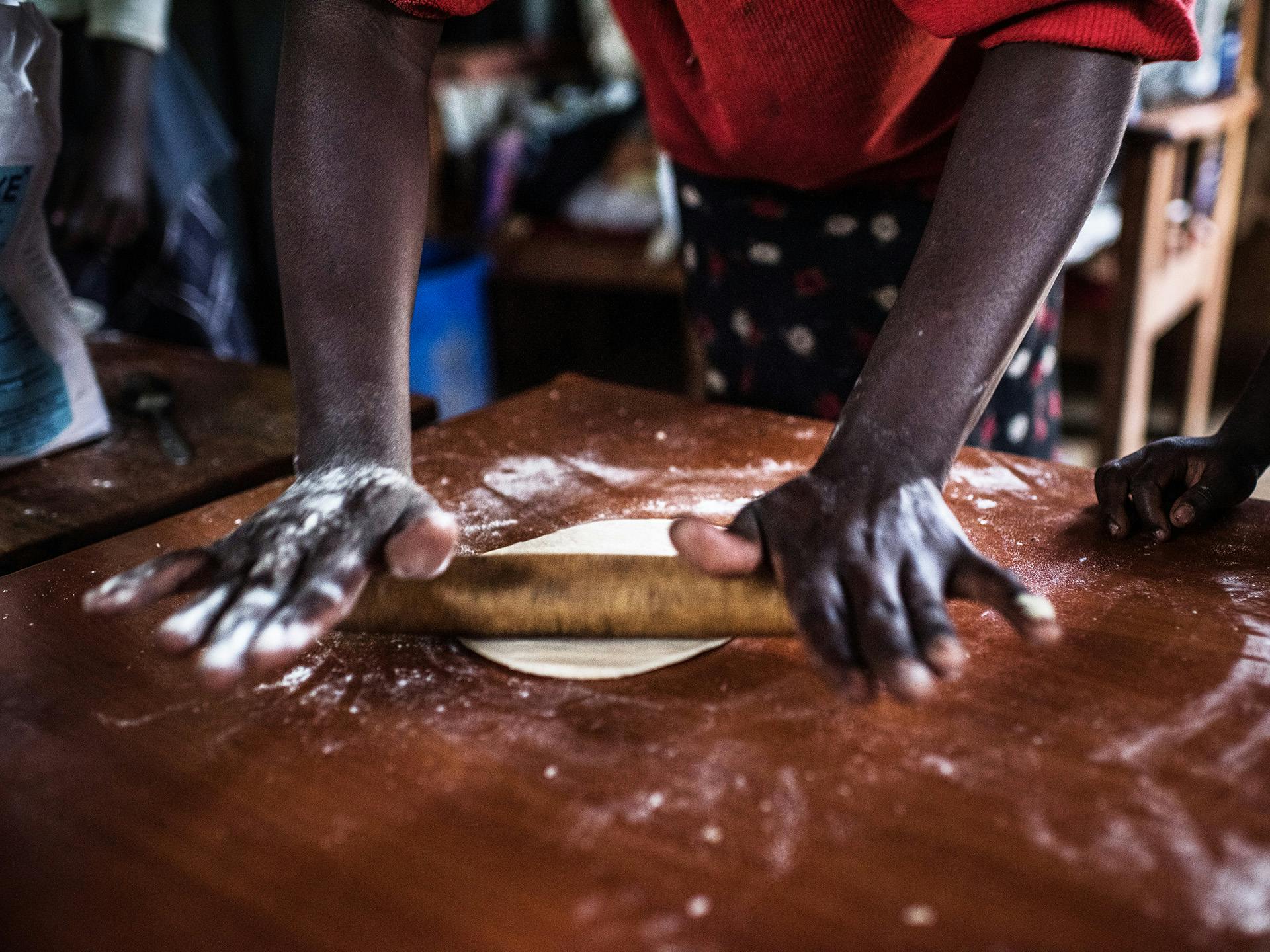 Two hands baking a dough
