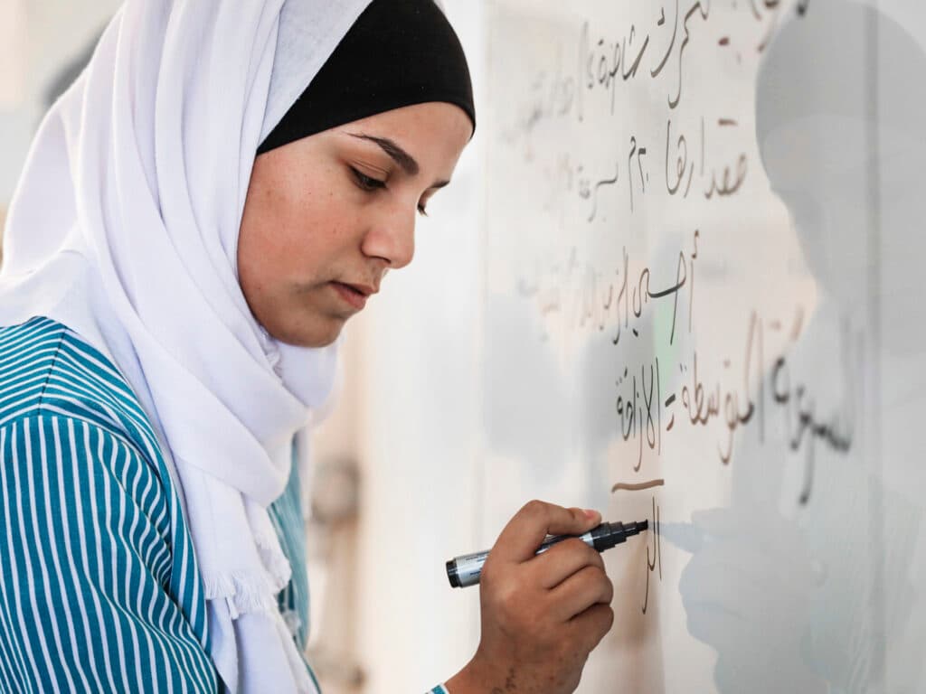 Girl writing on a board