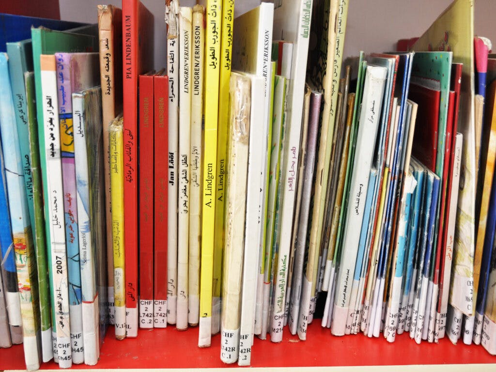 A photo of a lot of childrens' books in a shelf.