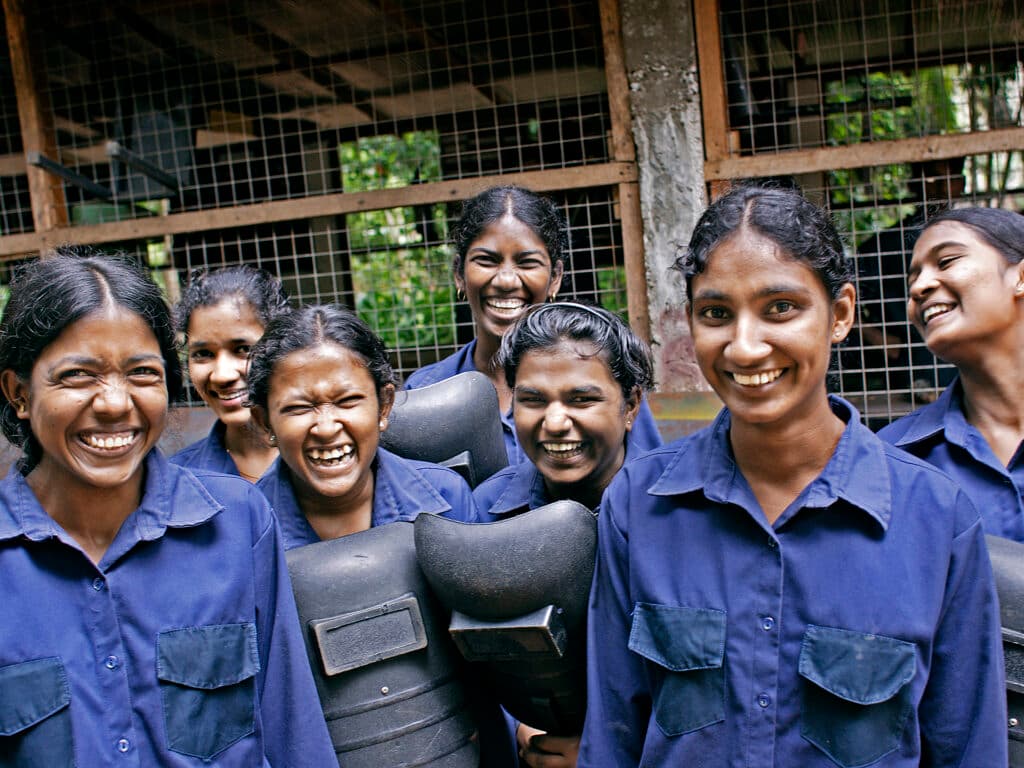 A group of women wearing blue working clothes.