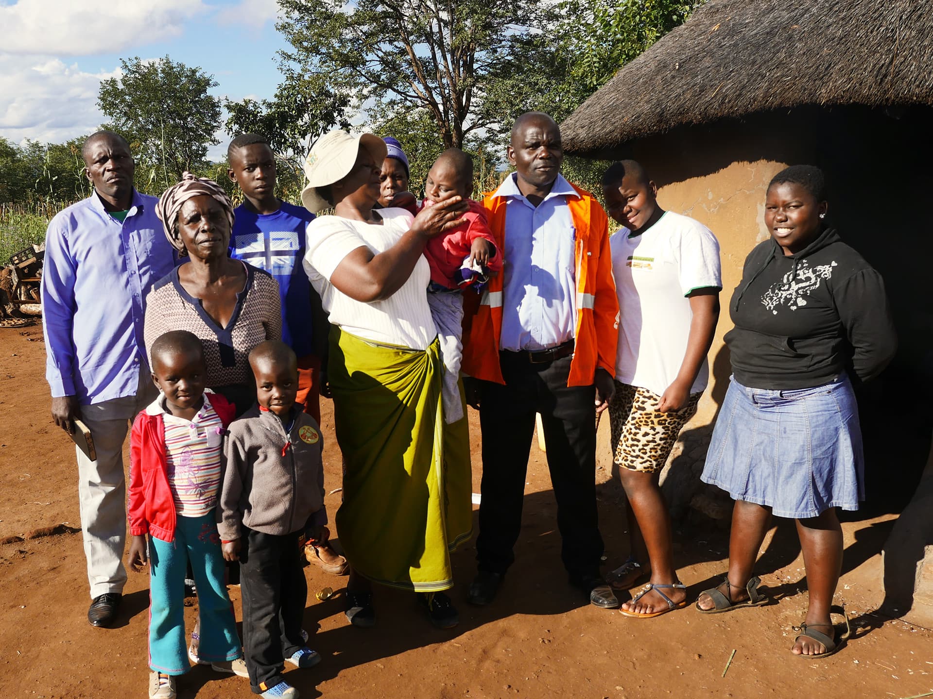 A big family standing outside their house