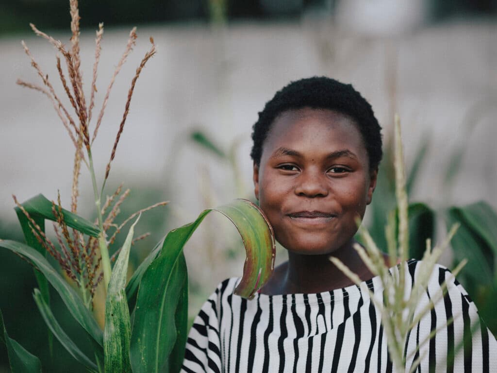 A closeup of a Zimbabwean woman in a field.