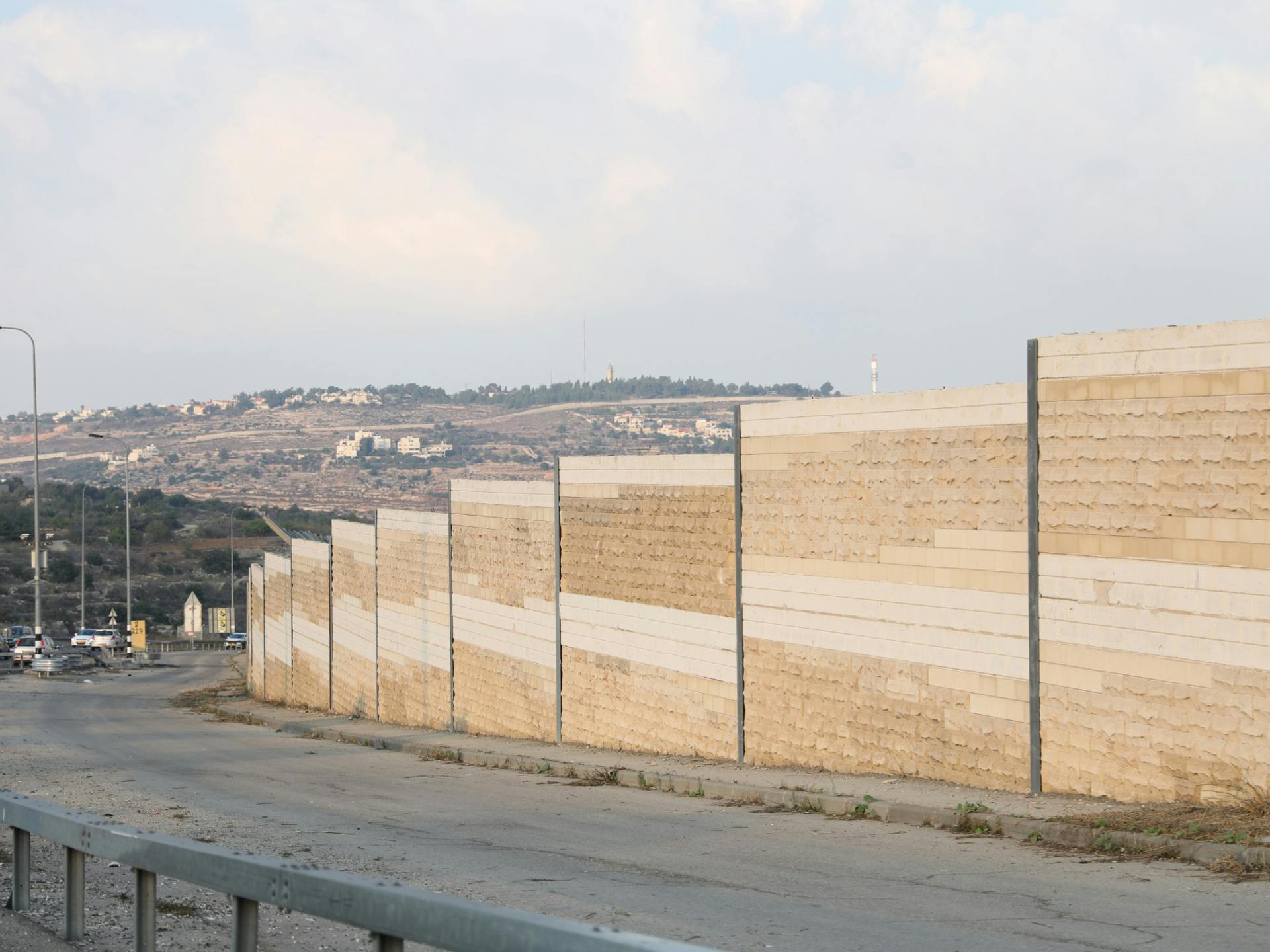 An image of a large wall leading down a hill.
