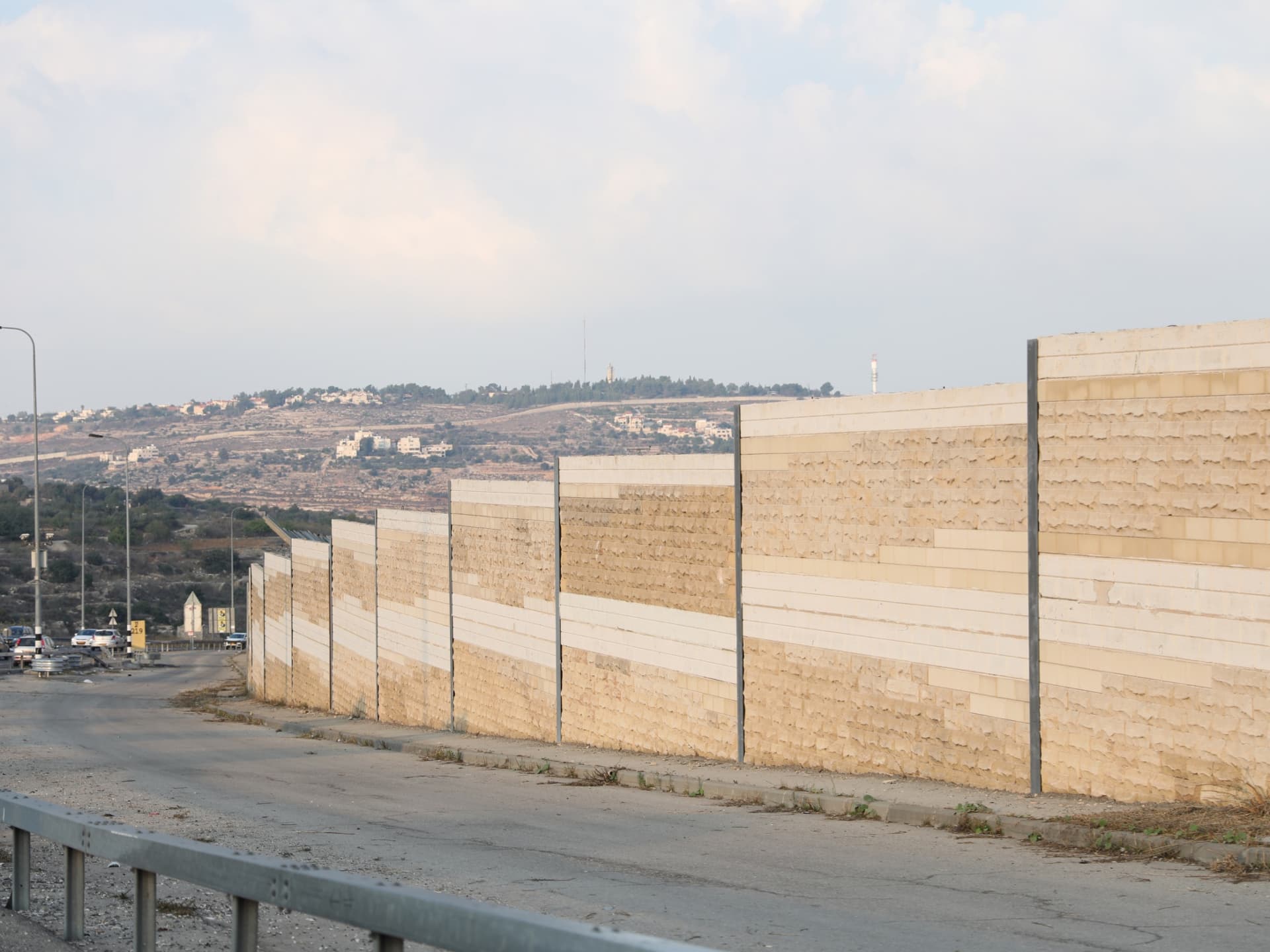 An image of a large wall leading down a hill.