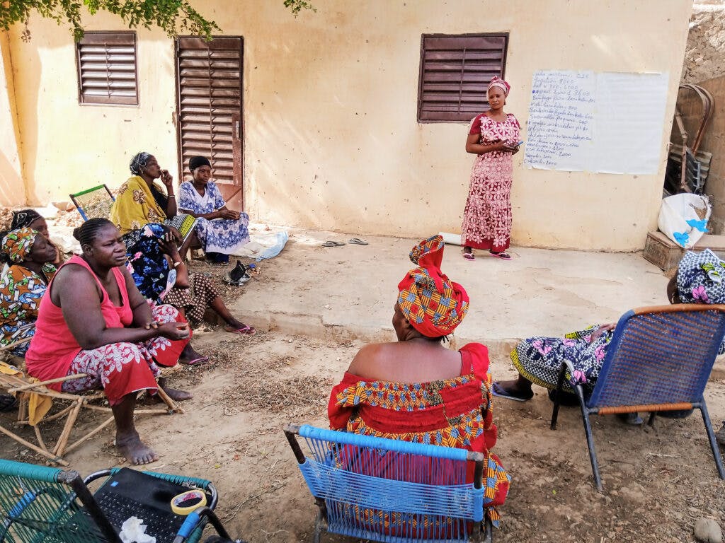 A group of Mali women holding a meeting outside