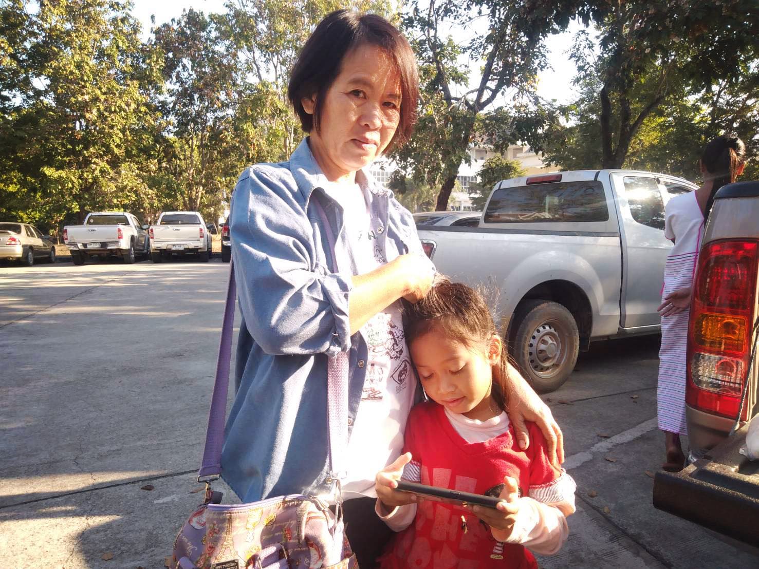 A woman standing with a child.