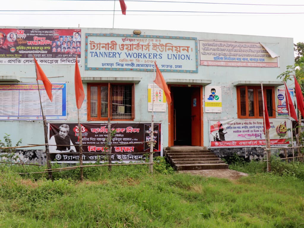 A house with signs on it that say: Tannery Workers Union.