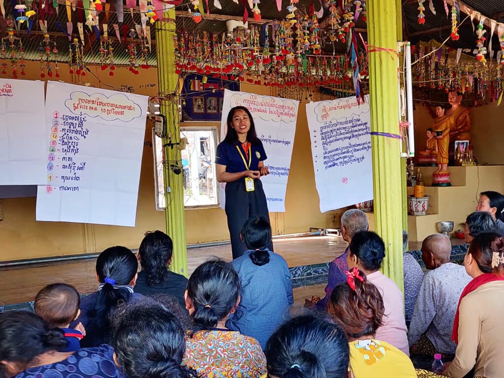 A woman standing in front of a group of people