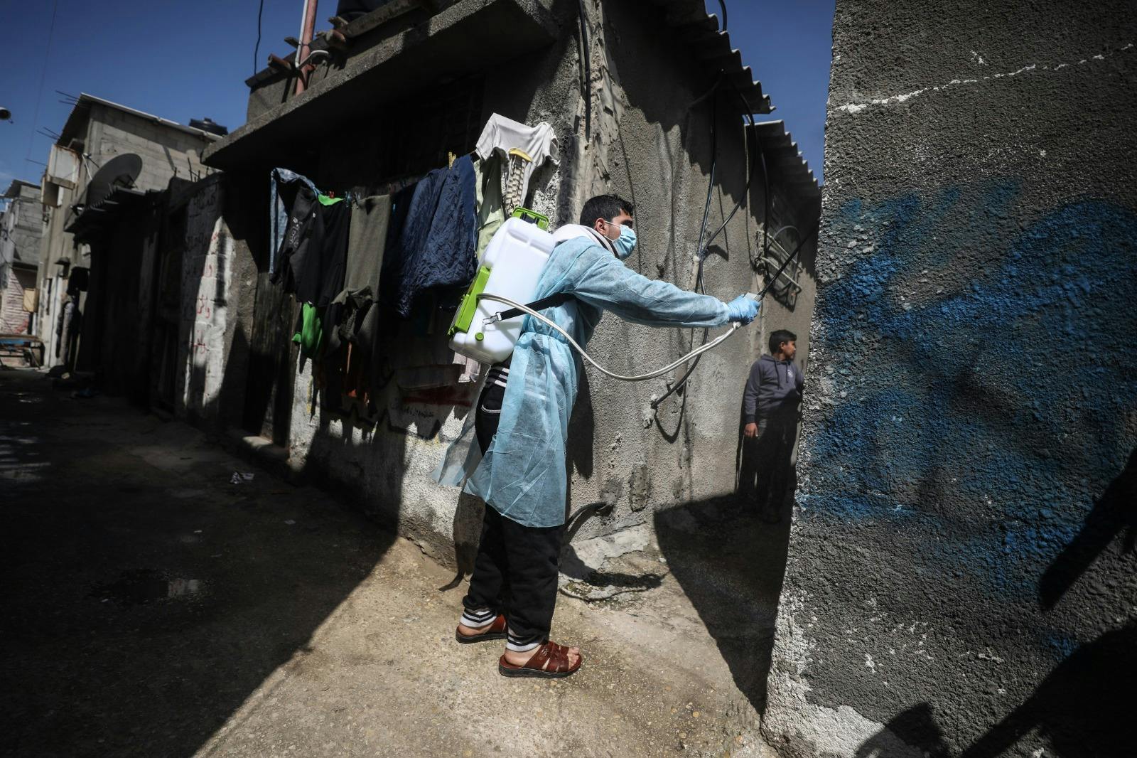 A health worker sanitising houses in a poor neighborhood in the Gaza Strip.