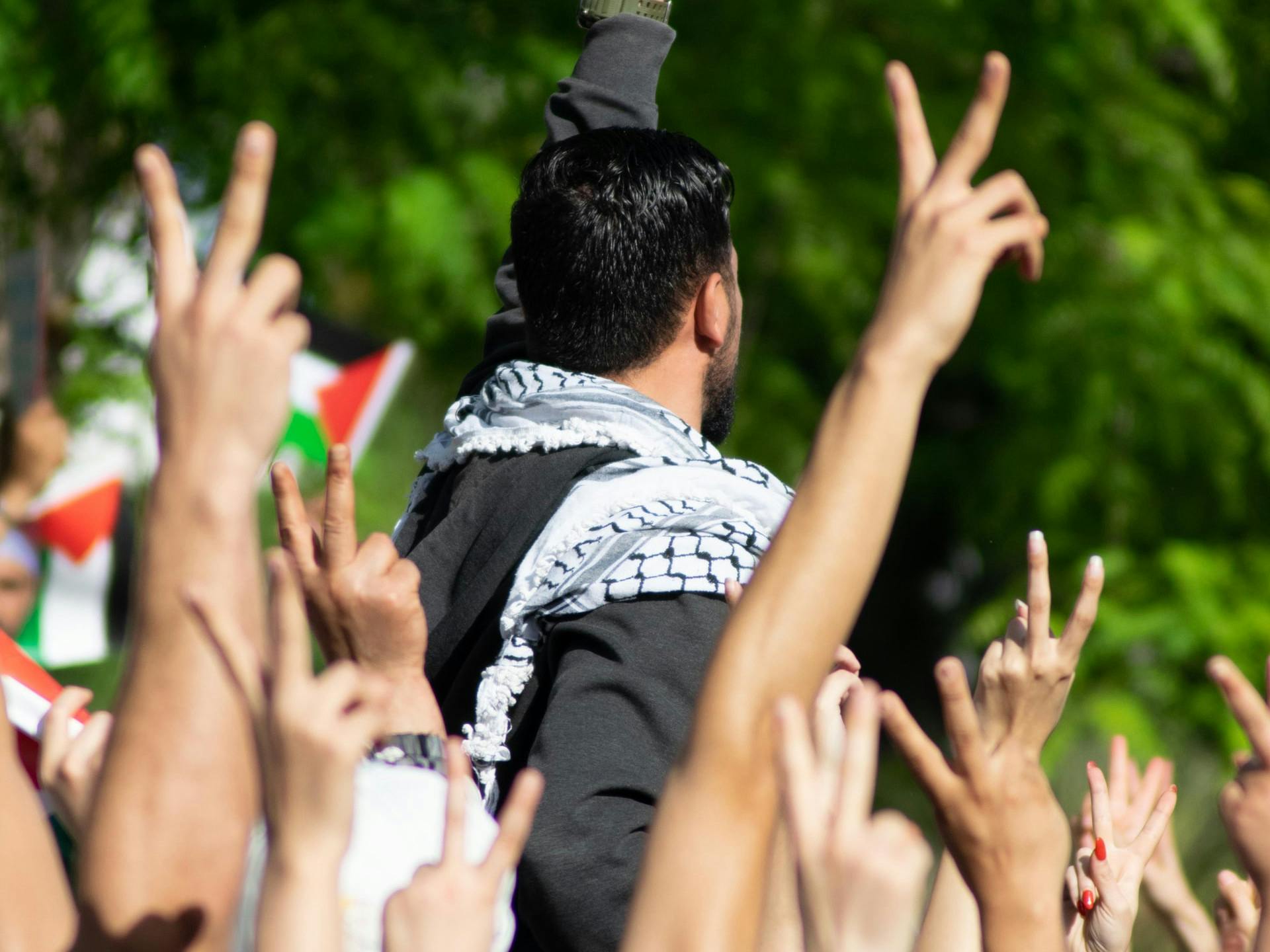 People in Tunis raising their hands at a solidarity demonstration for Palestinians.