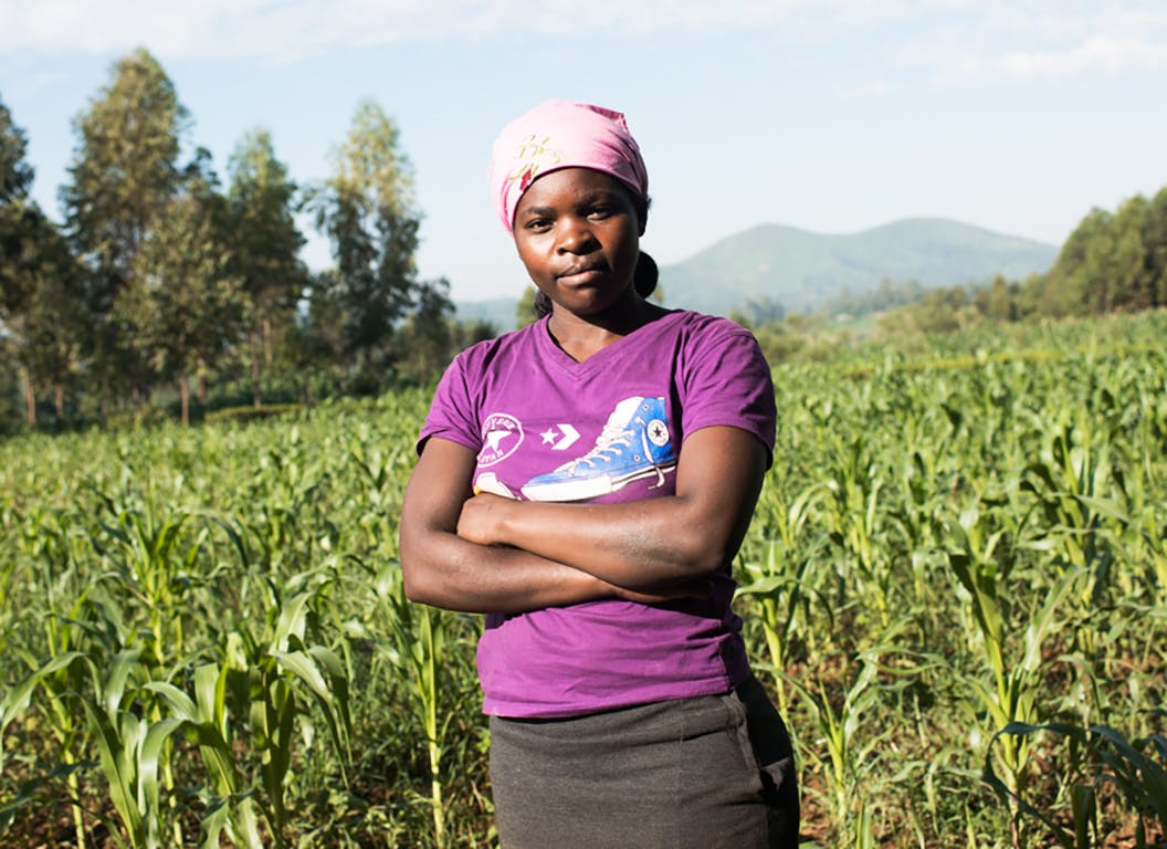 A Kenyan woman standing in a field.